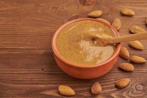 almond butter, raw food paste made from grinding almonds photo