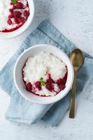 Rice Pudding. Vegan Coconut diet breakfast with coconut milk, raspberry, scandinavian minimalism photo