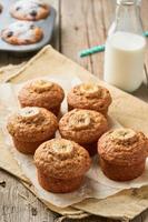 Banana muffin, side view, vertical. Cupcakes on old linen napkin, rustic wooden table