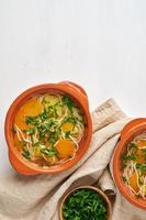 Healthy chicken soup with vegetables and rice noodles, fodmap dash diet, top view copy space photo