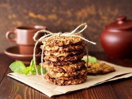 Homemade oatmeal cookies with banana, oats, nuts, eggs and flour free on brown dark wooden