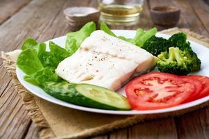 Steamed cod fish. Paleo, keto, fodmap healthy diet with vegetables photo