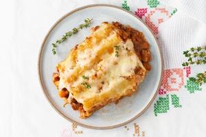 Cannelloni pasta with filling of ground beef, tomatoes, baked with bechamel photo