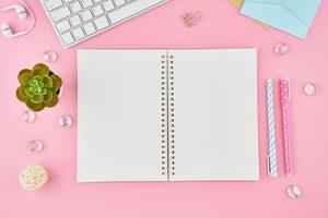 Blank notepad page in bullet journal on bright pink office desktop photo