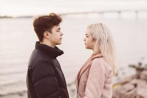 Teenage love concept. Cute brunette guy young blonde girl