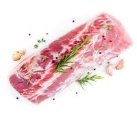 large piece of meat, raw pork carbonate fillet isolated on white background, with rosemary photo