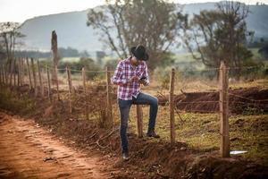 Farmer or country man using a smartphone on the farm. Internet 4G farmer. Social networks, online consultations. photo