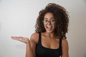 Portrait of young beautiful african american girl with afro. Girl wearing eyeglasses. Closeup. Studio shot. photo