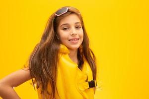 Child wearing life jackets. On yellow background. photo