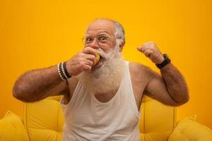 Portrait of a bearded man about to eat a apple. Senior having an apple. photo