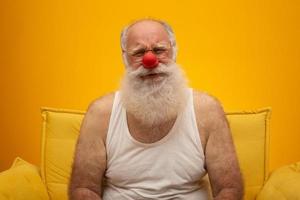 Unhappy old man with a red nose. All fools day. Elderly with red nose. photo