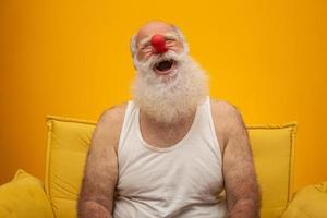 Happy old man with a red nose. All fools day. Elderly with red nose. photo