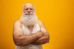 Old man with a long beard on a yellow background. Senior with full white beard. Old man with a long beard with sadness. photo