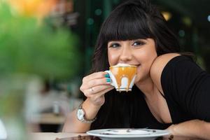 Woman drinking coffee table. Women in cafe. photo