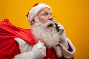 Holly jolly x mas Santa in headwear, costume, black belt, white gloves brings gifts for kids, prepared to celebrate, sale promotion, winter december, chatting on telephone. Santa talking on the phone
