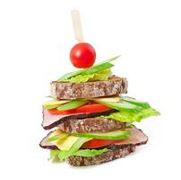 Sandwich with ham and fresh vegetables on a wooden background photo