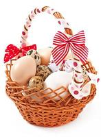 Easter eggs and basket on a wooden background photo