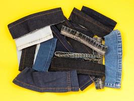 Jeans pieces on a yellow background. photo