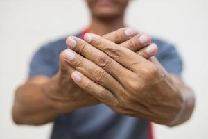 Close-up of both hands of a man numb to his nerve endings. photo