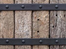 Background of old logs, which are fixed with steel. photo