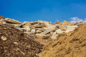 A view of the rubble pile of concrete blocks obtained from the demolition of an old road. photo