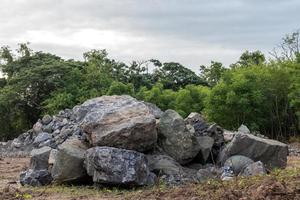 Two large granite piles near the forest. photo