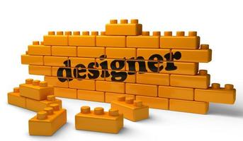 designer word on yellow brick wall photo
