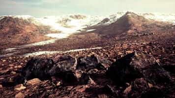 Sunrise in a rocky desert with shadows cast by the hills video