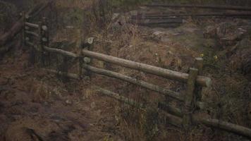 An old wood fence with a country field behind it video