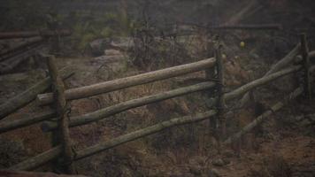 An old wood fence with a country field behind it video