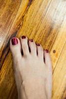 women feet after pedicure with red nails photo