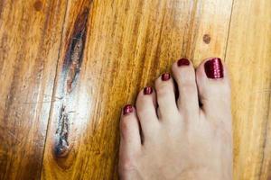 women feet after pedicure with red nails photo