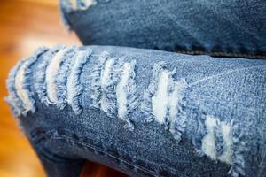 leg of women in fragmentary and torn jeans photo