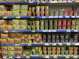 Georgetown, Penang, Malaysia, 2021 - Rows of packet and cup noodles for sale inside a supermarket at Farlim Ayer Itam photo