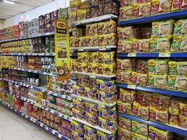 Georgetown, Penang, Malaysia, 2021 - Rows of packet and cup noodles for sale inside a supermarket at Farlim Ayer Itam