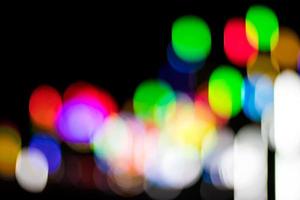 Abstract blurred bokeh, lots of colorful lights in the dark. photo