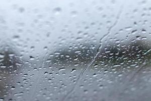 Blur the background of rain drops on the windshield. photo