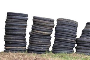 Many old motorcycle wheels stacked together. photo