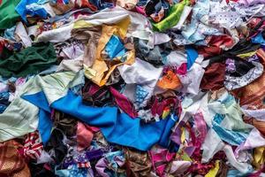 The background of the rag pieces of various colors are stacked together in a scattered mess. photo