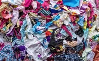 The background of the rag pieces of various colors are stacked together in a scattered mess. photo