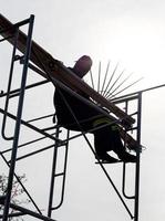 Silhouette workers on the scaffolding. photo