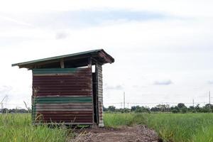 Old zinc bathroom on rice paddies. photo