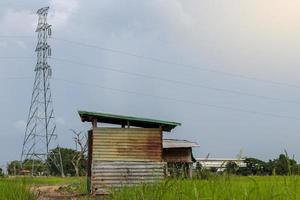 Low view zinc huts with high voltage towers. photo