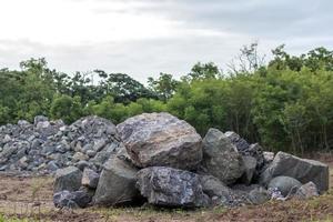 Two large granite piles near the forest. photo