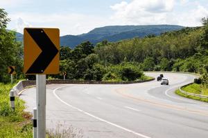 Turn sign on the curve of the mountain. photo