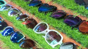Many black glasses on artificial grass in wooden frames. photo