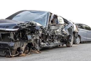 Low side view of a sedan that was smashed in a fatal collision. photo