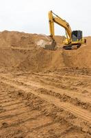 Backhoe on the sand track. photo