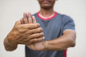 Close-up of a man bending his hand due to nerve endings. photo