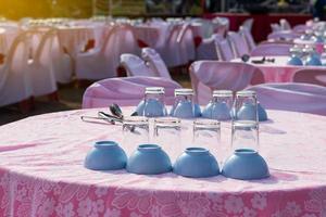 Glasses and cups are placed on tablecloths. photo